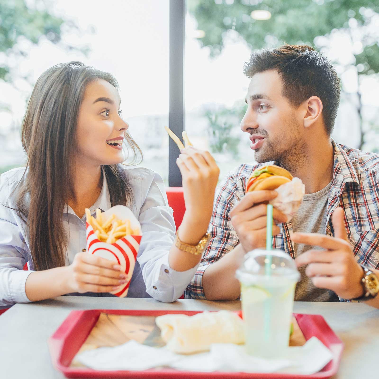 young couple eating fast food together
