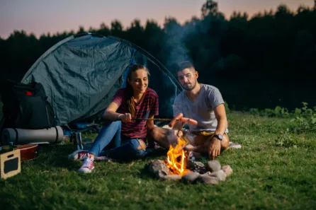 couple on a romantic camping trip at sunset